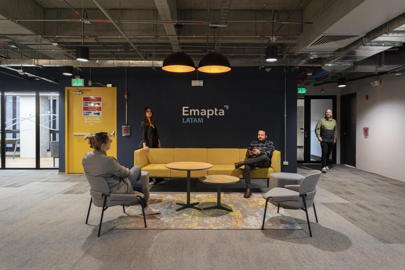 Emapta Offices - Employee lounge area with industrial aesthetic and comfortable sofa seating - Contract Workplaces.jpg